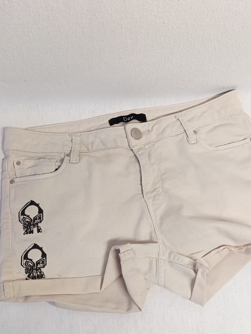 Dex Cream Cotton Shorts with Folded Hem And Glittery Black Skull Graphic Accents